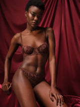Tamia Balcony Bra paired with Tamia Skirted Thong in mocha-colored bespoke embroidery and silk bound strapping, featuring a scalloped edge