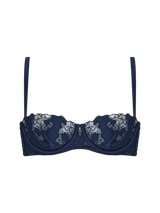 A deep blue, floral patterned half cup bra with silk-cased underwire, scalloped edges, adjustable silk straps, a hook and eye closure, and golden hardware.
