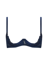 A deep blue quarter cup bra with intricate embroidery along the edges and adjustable straps.