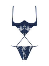 An intricate, navy blue, floral embroidered Coco de Mer Arella Wired Open Playsuit with silk bound crescent cups and adjustable straps.