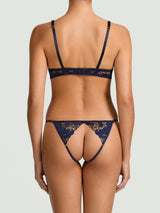 An intricate, navy blue, floral embroidered Coco de Mer Arella Wired Open Playsuit with silk bound crescent cups and adjustable straps as shown on model