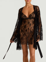 A black Leaver's lace robe with scalloped hem and sleeves, featuring a jet black silk tie shown on model with matching Hera Slip