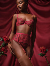 Naraya Balcony Bra, Brazilian Knicker and Suspender Belt with red lurex Leaver's lace in a floral design, scalloped eyelash trim and adjustable silk straps shown on model as an alluring set