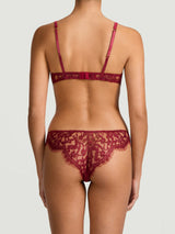 A red lurex Brazilian knicker with intricate Leaver's Lace pattern and scalloped edges.