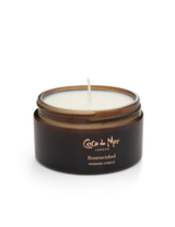 A Coco de Mer massage candle infused with rose and sandalwood, in an amber glass jar, made of low melting point soya wax to drizzle delicately onto the skin with no fear of being burnt