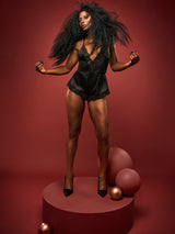 Dame Denise Lewis wears Coco de Mer's Seraphine Teddy, made with luxurious silk and corded Leaver's lace trim, featuring a plunging neckline, low V back, and adjustable crossed silk straps