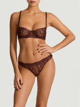 Tamia Balcony Bra paired with Tamia Skirted Thong in mocha-colored bespoke embroidery and silk bound strapping, featuring a scalloped edge