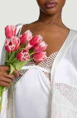 Model wears aa UK size M in the ivory silk slip with sheer scallop edge embroidery over the chest and scallop edge embroidery bottom edge detailing paired with the matching ivory robe in one size