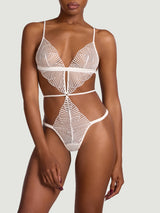 Model wears a UK size M in the Athena Ivory playsuit with open back and scallop edge embroidery