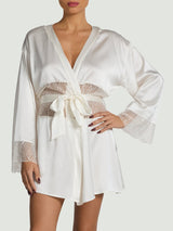 Model wears a silk ivory robe with scallop embroidered detailing on the sleeve and waist, with an ivory silk tie