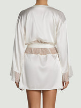 Model wears a UK size M in ivory silk robe with scallop edge detailing on the waist and the sleeves, closed with an ivory silk tie from the back