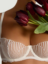 Model wears a UK size 34B Athena Ivory balcony bra with scallop embroidery close up