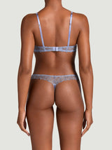 Model showing the back of the Coco de Mer Esme Balcony bra and Skirted Thong. Made in a powder blue silk and bespoke floral embroidery.