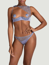 Model wearing the Coco de Mer Esme lingerie set in powder blue. Asymmetric quarter cup bra and open knicker silhouette. Made from silk and sheer floral embroidery.