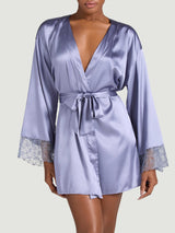 Coco de Mer silk robe worn on a model. A powder blue silk with geometric floral embroidery at the cuffs.