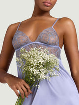Model wearing the Coco de Mer Esme silk slip dress in powder blue. Features sheer geometric floral embroidery at the bust.