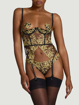 Black quarter cup underwire basque with gold embroidery and attached silk suspender straps worn with black open knickers with gold embroidery and sheer black suspenders