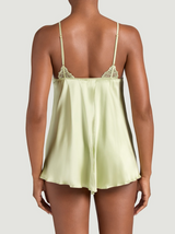 Model wears a pistachio green silk baby doll. This is the back of the image and has embroidered strap details and a split in the middle