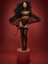 Dame Denise Lewis wears a black Coco de Mer Hera set made with intricate Leaver's lace detailing, including Luxurious Balcony Bra, Suspender Belt, Brazilian Knicker and Robe