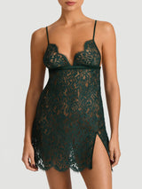 Coco de Mer Isara forest green slip dress made of lace, featuring adjustable straps, delicate scallops, and a slit on the left thigh, shown on model.