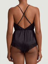 A black silk teddy with corded Leaver's lace trim, featuring a plunging neckline, low V back, and adjustable crossed silk straps. It has a high leg and pleated short design as shown on the model