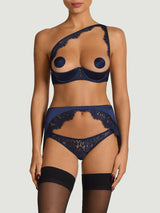 Model wears a UK size M in the open suspender knicker with scallop edge sapphire lace detailing across the front, paired with the sapphire lace quarter cup bra in a UK size M attached to sheer hold ups by silk suspender straps from the front