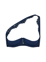 Sapphire lace quarter cup bra with silk quarter cups and underwire across the front, lace detailing carries across the chest and over the one shoulder attached to silk straps from the front on a clear background