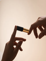 Vibrating bullet toy shown with a pair of hands for comparative sizing, the bullet is 6.25 centimetres by 1.7 centimetres by 1.7 centimetres, shown on a white background 