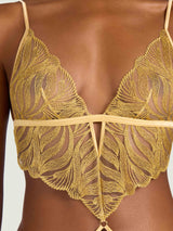 A model wearing lingerie with gold embroidery on a closed style playsuit with a close up view