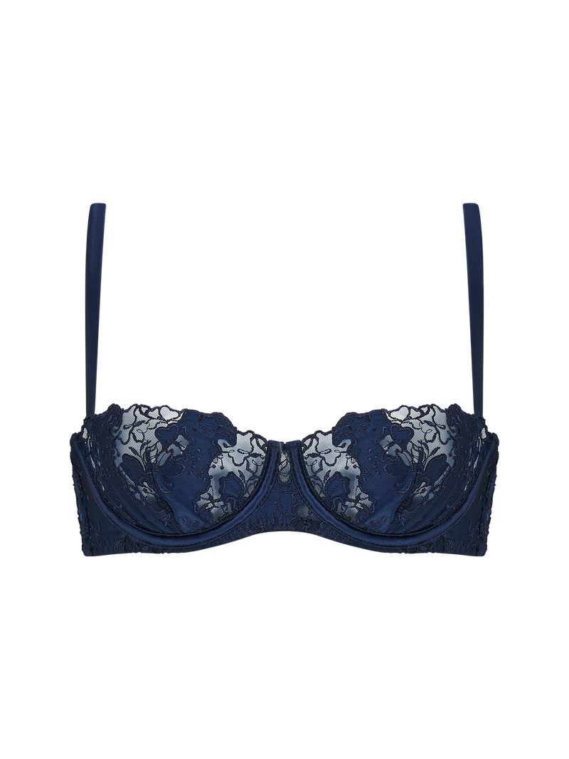 A deep blue, floral patterned half cup bra with silk-cased underwire, scalloped edges, adjustable silk straps, a hook and eye closure, and golden hardware.