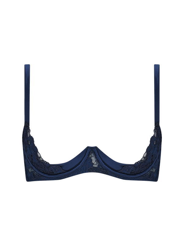 A deep blue quarter cup bra with intricate embroidery along the edges and adjustable straps.