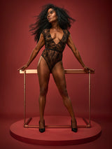 Dame Denise Lewis wearing Coco de Mer's Hera Bodysuit made in a luxurious black Leaver's lace with scalloped edges