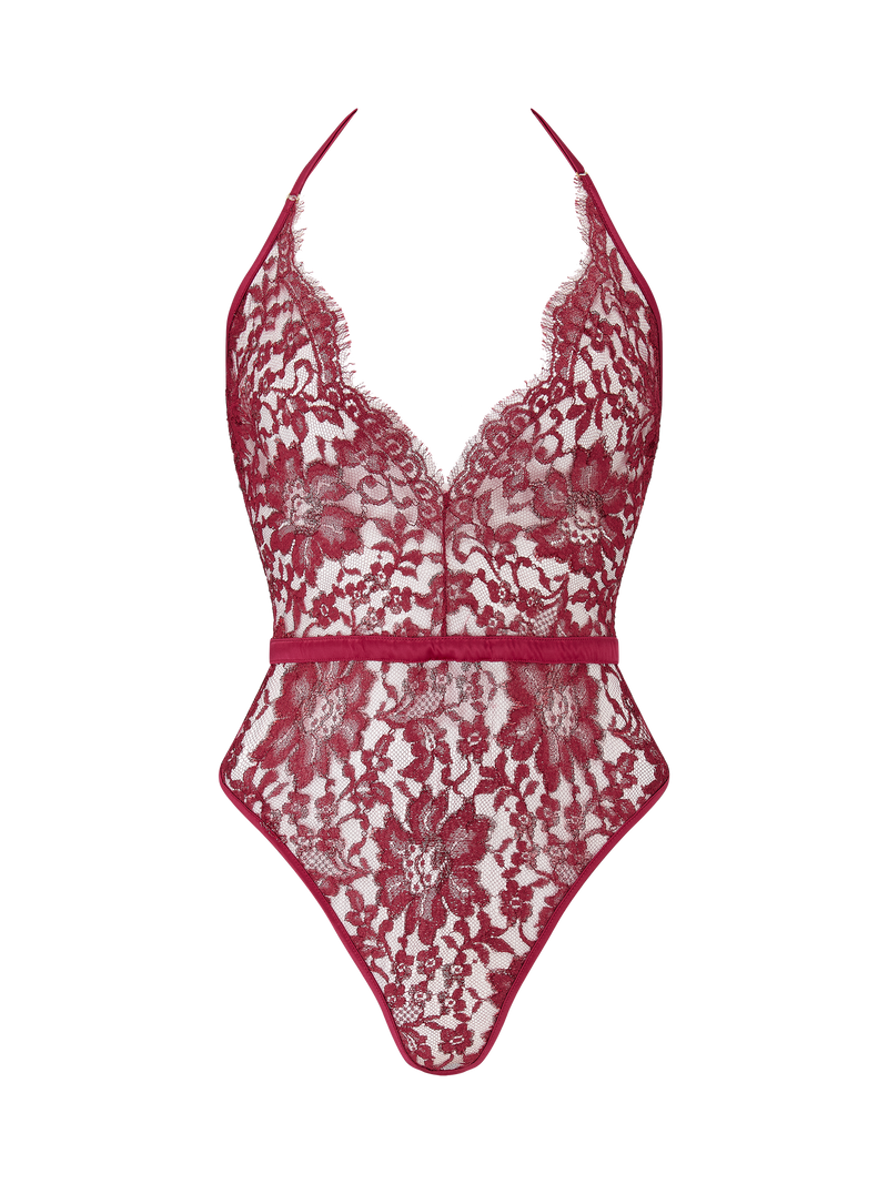A red lurex Leaver's lace playsuit with a halterneck shape, delicate eyelash trim at the bust, and a silk band at the waist. It includes sleek adjustable silk straps and delicate golden hardware.
