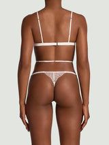 The back of the Athena Ivory Playsuit on a model against a white backdrop. 