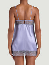 Model showing the back view of the Coco de Mer Esme slip. Features powder blue silk and sheer geometric floral embroidery.