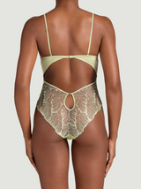 Pistachio green bodysuit with floral embroidery on a model whose back is facing us. The bodysuit shows a cut out at the back of the torso, with the embroidered panel going over the bum. 