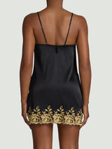 Model wears a UK size M in the black silk slip with gold rose embroidery detailing across the chest and down the front into a slit on the thigh, embroidery then continues throughout the hem shown from the back 