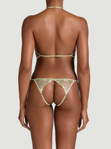 Mint green embroidered lingerie on a model. Model stands with her back facing us. 