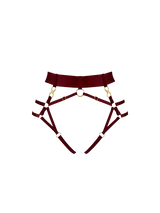 Front image cut out of morello harness brief shown with a thick high waist strap, attached to multiple leg straps with gold attachments, gold ring detailing shown centrally on the front 