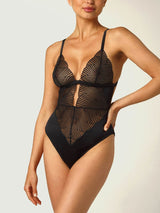 A black Coco de Mer Athena Bodysuit with graphic embroidery and a deep plunging neckline. It includes fan edged cups, an underbust band of jet black silk, adjustable silk straps, and gold hook and loop fastenings.